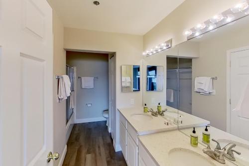 a bathroom with two sinks and a large mirror at Waters Edge in Lake Ozark