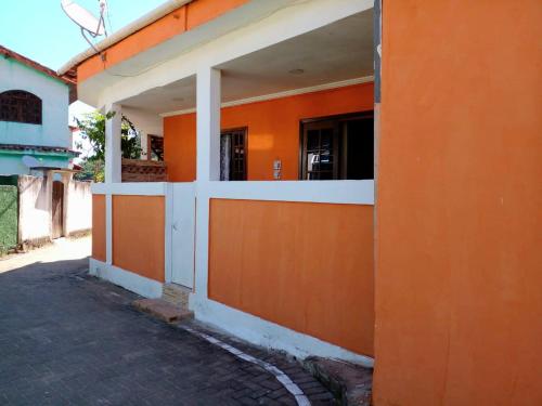an orange and white building with a window at Suite Baia dos Corais in Angra dos Reis