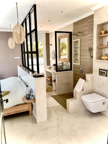 a bathroom with a bed and a shower and a toilet at Villa targa in Mirleft