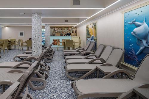 a row of empty chairs in a waiting room at Hotel Podgorie Spa in Bukovel