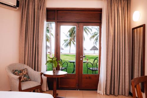 a room with a door with a view of a patio at White Sands Hotel in Dar es Salaam