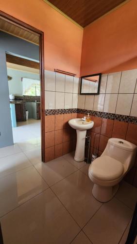 a bathroom with a toilet and a sink at Selvática del Toro in Bajos del Toro