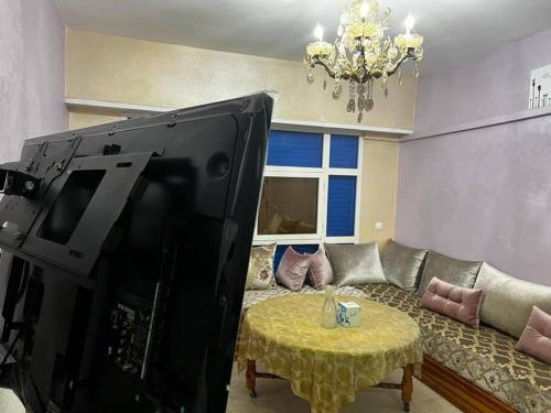 a living room with a couch and a large television at Agadir Morocco Furnished apartment for long-term rental in Agadir