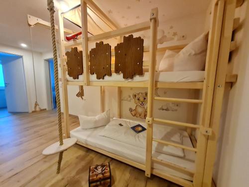 a room with two bunk beds in a room at Familienhotel Löwen in Nesselwang
