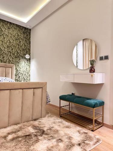 a bedroom with a bed and a mirror and a rug at LA Perle de la medina in Rabat