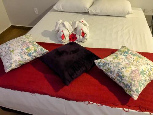 a white bed with two pillows on it at Hotel Pousada Riacho da Areia in Águas de Lindóia