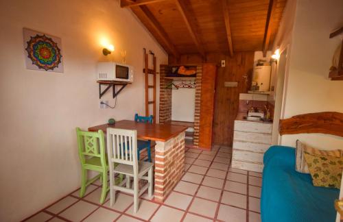 una piccola cucina con tavolo e sedie in camera di June en el Uritorco a Capilla del Monte