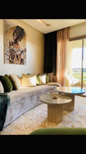 a living room with a couch and a table at Luxueux Appartement Prestigia in Marrakech