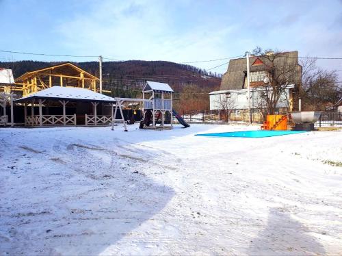 an empty playground with snow on the ground at Margo in Yaremche