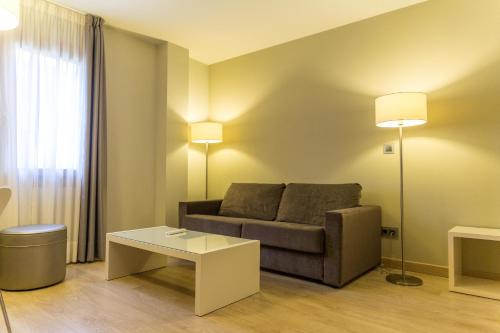 a living room with a couch and a coffee table at Tinas de Pechon in Pechón