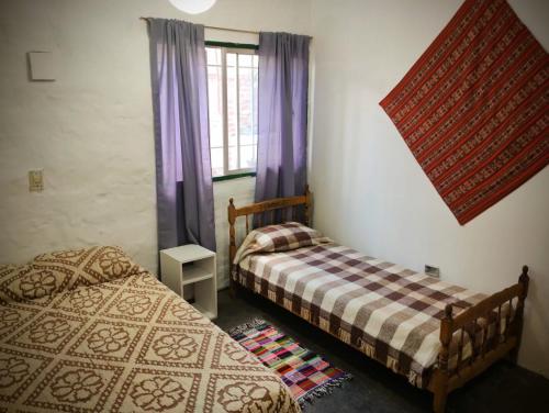1 dormitorio con 2 camas y ventana en Casita Festiva en Santa María