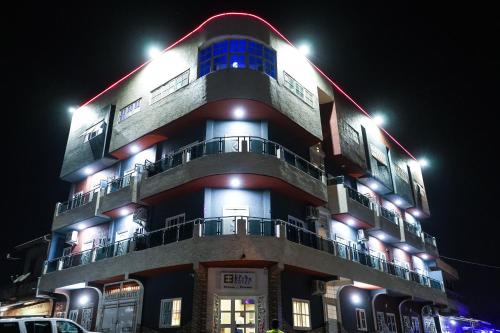 a building with lights on top of it at night at EKA ELITE HOTEL in Lomé