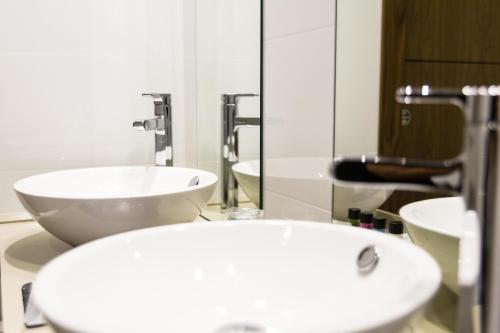 a bathroom with a sink and a large mirror at Tinas de Pechon in Pechón