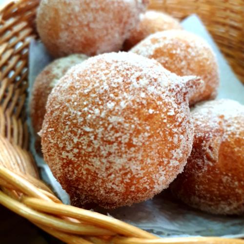 a bunch of sugar covered donuts in a basket at Pousada Déllis in Visconde De Maua