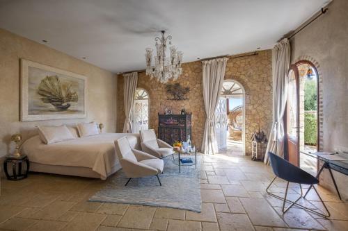 a bedroom with a bed and a couch and a fireplace at La Sultana Oualidia in Oualidia