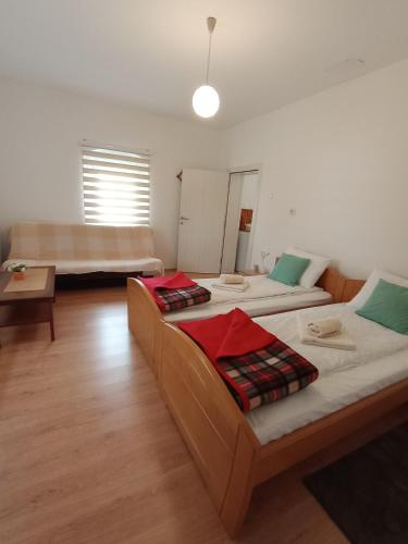 a room with two beds and a couch at Verina kuća in Kosjerić
