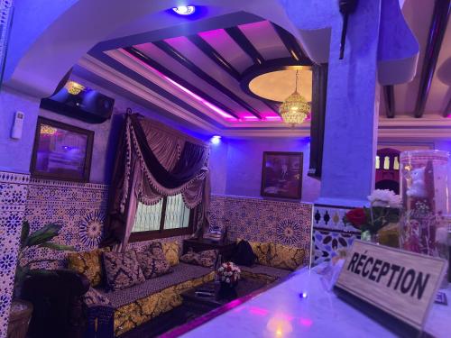 a living room with a couch and purple lighting at Maison d'hôtes Afassi in Chefchaouen