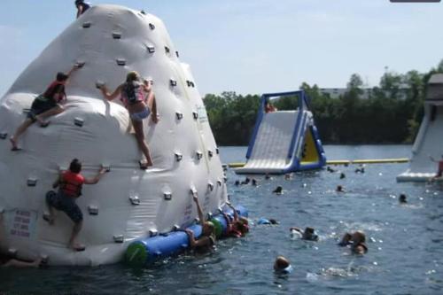 a group of people playing in the water on an inflatable at 3 BR Centrally Located Poconos Chalet in Tobyhanna