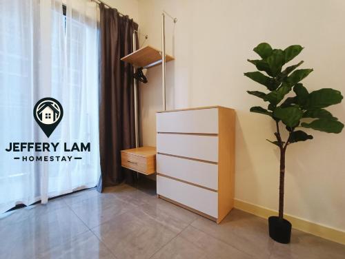 a room with a dresser and a potted plant at Imperio Residence Melaka by Jeffery Lam Home Management in Melaka