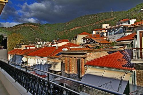 a group of buildings with red roofs and a mountain at my own way in Nafpaktos
