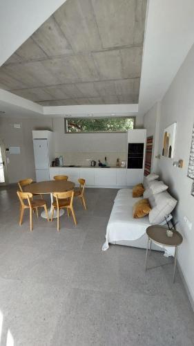 a bedroom with a bed and a table and chairs at Villa Casa Gavion in Los Menores