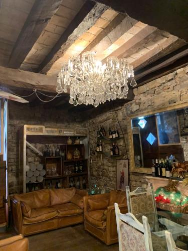 a living room with couches and a chandelier at La baia dei lupi in Rezzano