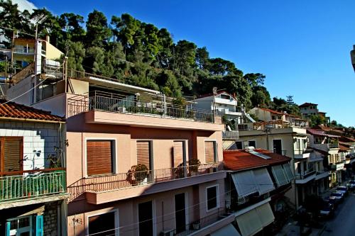 a group of buildings with a mountain in the background at my own way in Nafpaktos