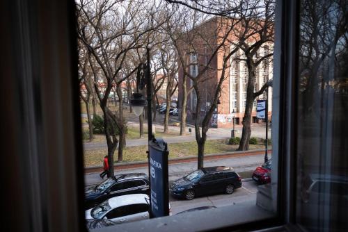 a view from a window of cars parked on a street at Apartment HYGGE in Subotica
