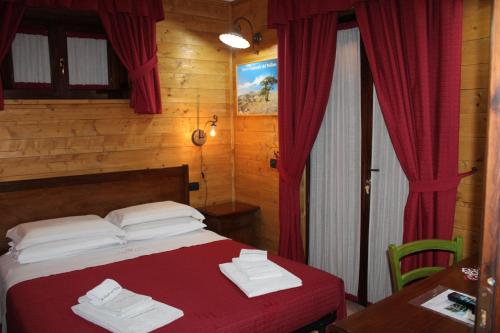 Posteľ alebo postele v izbe v ubytovaní Le Chalet del Pollino