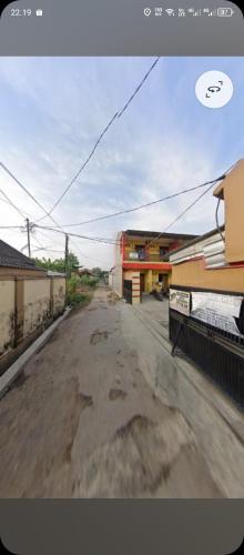 an empty street with buildings and a frisbee in the air at Pondok Kost Aurel 