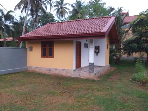 a small house with a red roof at Bel vedere in Minuwangoda