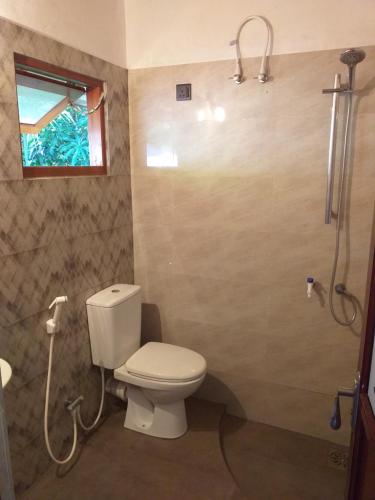 a bathroom with a toilet and a shower at Bel vedere in Minuwangoda