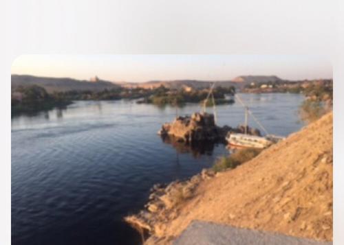 a view of a river with a boat in it at Shipa's nubian house in Aswan