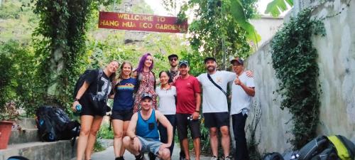 a group of people posing for a picture under a sign at Hang Mua Eco Garden in Xuân Sơn