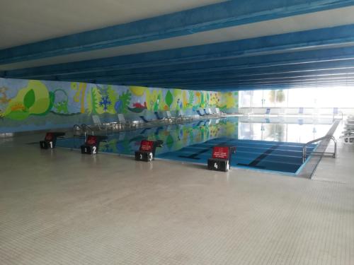a gymnasium with a row of blue mats at La Casa Shabby in Marilleva