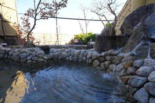 a stream of water with a rock wall at Kaigaku Onsen Resort Shirahama in Shirahama