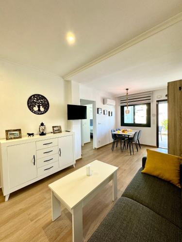 a living room with a couch and a table at La Zenia Boulevard & Beach House in Orihuela Costa