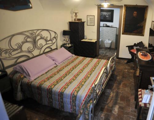 a bedroom with a bed with a colorful blanket at Agriturismo La Contessa in Finale Ligure