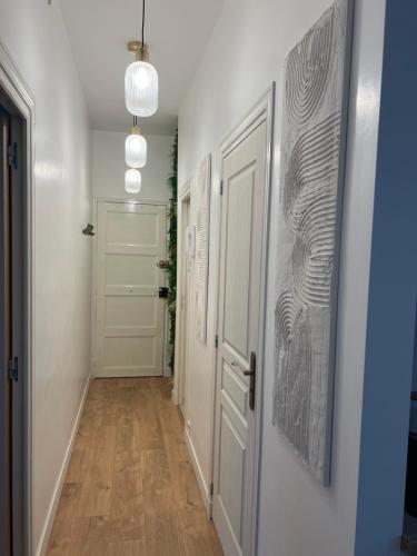 a hallway with a white door and a hallway with a hallway at Spa jacuzzi Caen centre in Caen