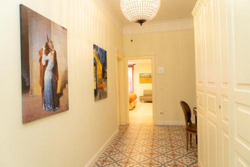 a hallway with two paintings on the wall at Domus Sibyllina, Palazzo Cavalcanti in Naples