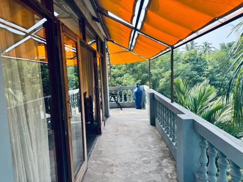 a balcony of a building with an orange roof at Casa Da Praia in Candolim