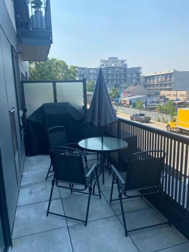 a patio with a table and chairs on a balcony at Spacious 2-bed, 2-bath condo in downtown Kelowna! in Kelowna