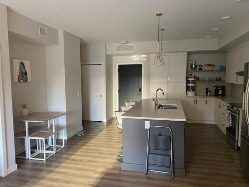 a kitchen with a sink and a counter top at Spacious 2-bed, 2-bath condo in downtown Kelowna! in Kelowna