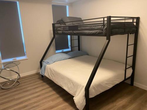 a bedroom with two bunk beds and a desk at Spacious 2-bed, 2-bath condo in downtown Kelowna! in Kelowna