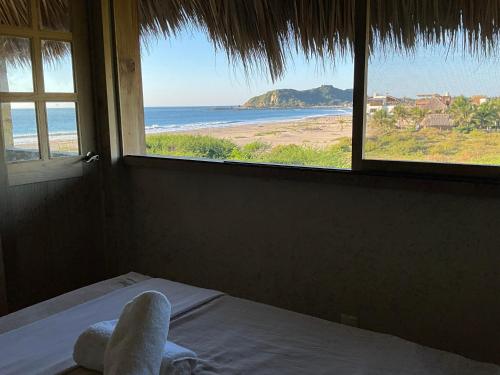 a bedroom with a bed with a view of the ocean at Casa Gitana in Chamuscadero