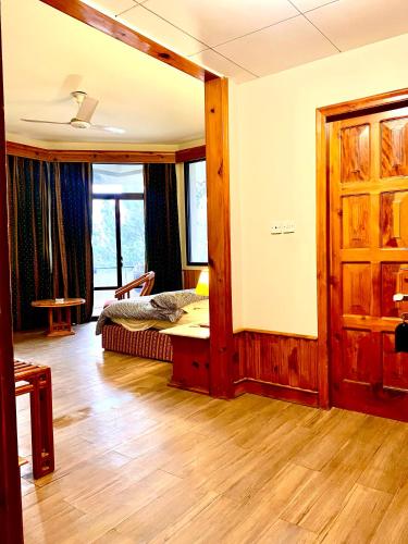 a living room with a bed and a window at Rock City Resort in Mingora