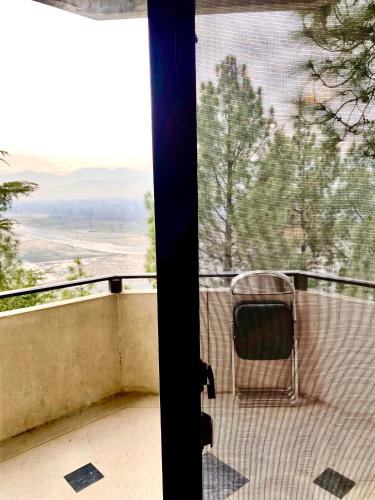 a chair sitting on a balcony with a view at Rock City Resort in Mingora