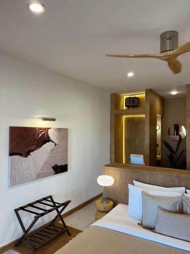 a bedroom with a bed and a painting on the wall at Rimtalay Resort Koh Larn in Ko Larn