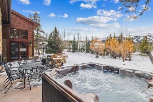 a hot tub in the snow next to a house at Trot Ski-House in Breckenridge