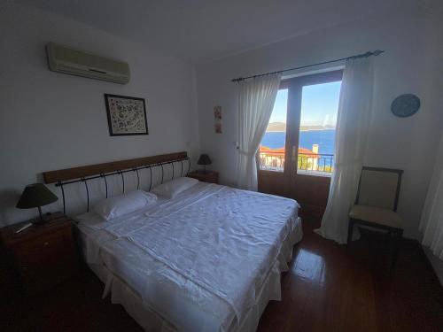 a bedroom with a bed and a large window at Private Luxury Villa with Pool in Kaş Peninsula in Kas